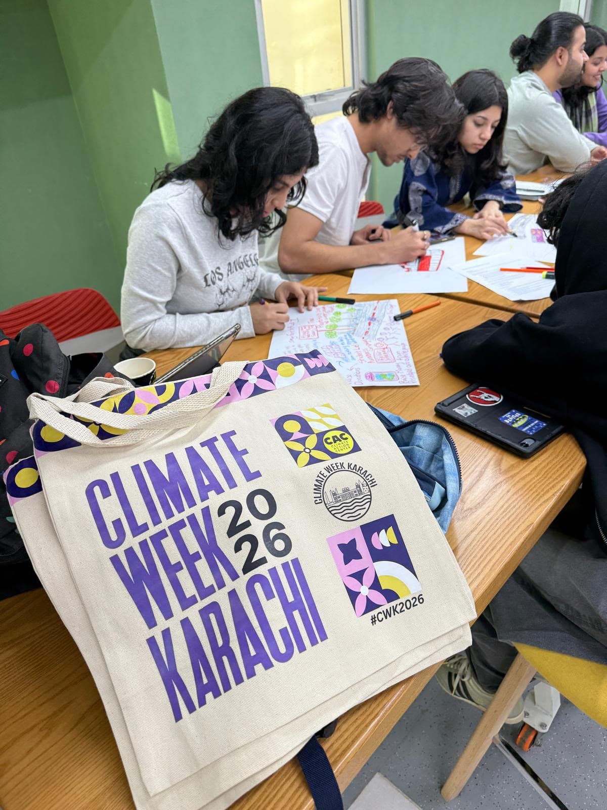 Climate Week Karachi tote on a table where participants are drawing