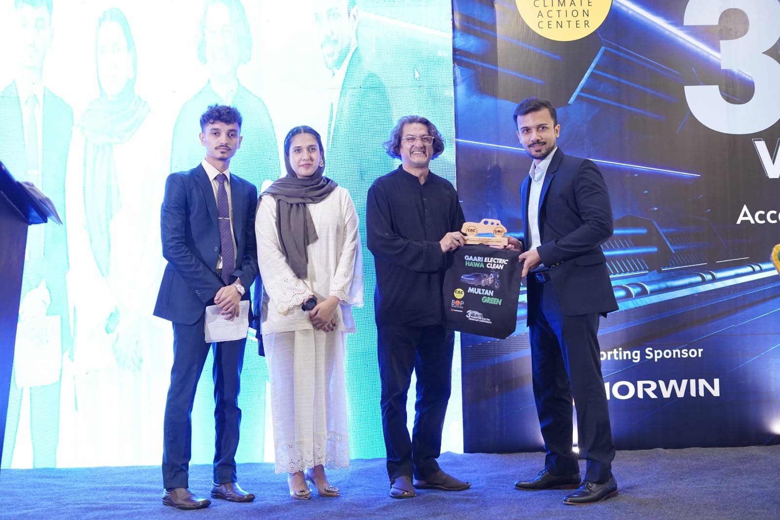 Four participants presenting an award at a climate event